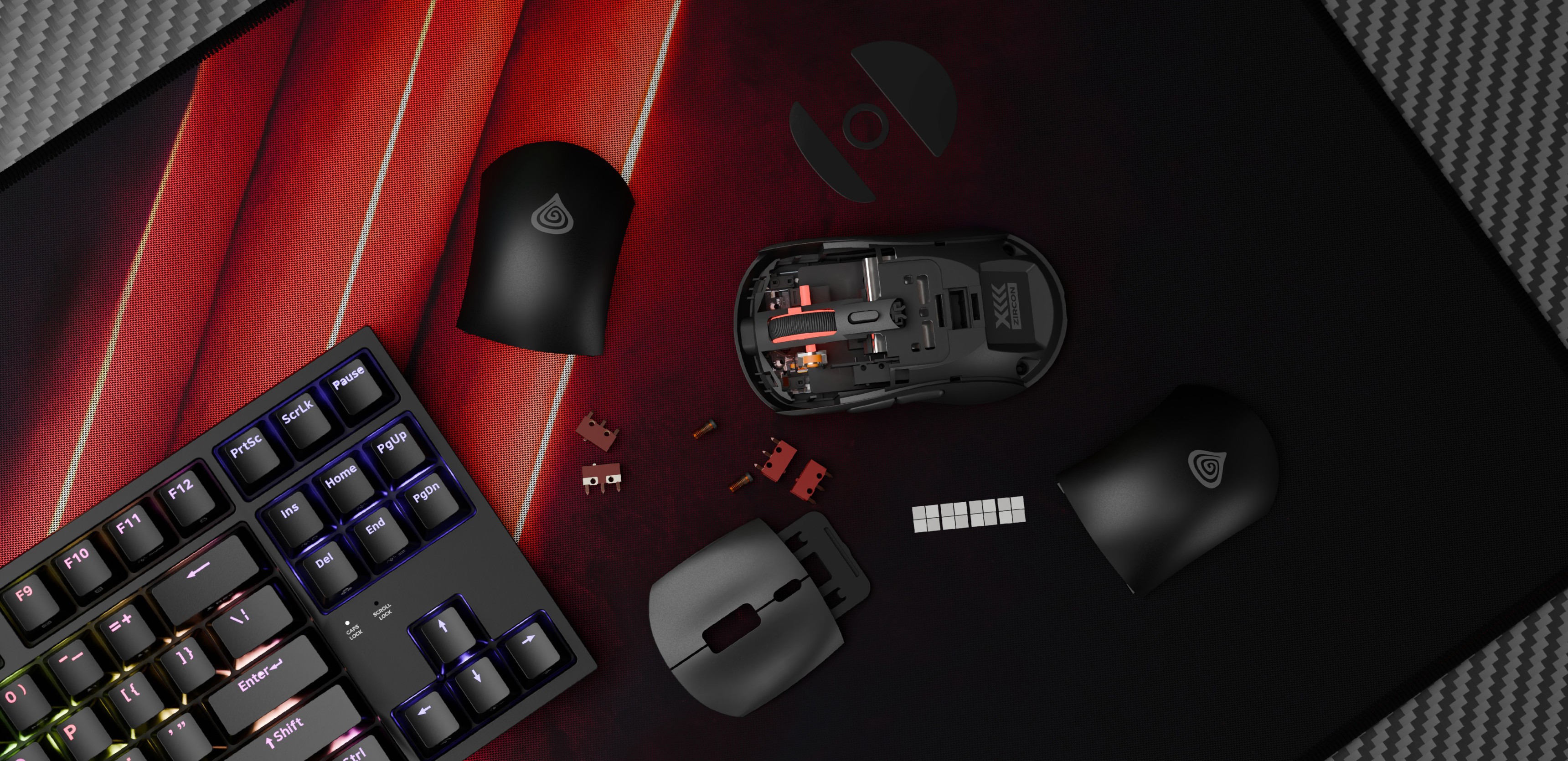 Ratón inalámbrico para juegos Genesis Zircon XIII en negro, con cubiertas y componentes extraíbles sobre una alfombrilla texturizada junto a un teclado