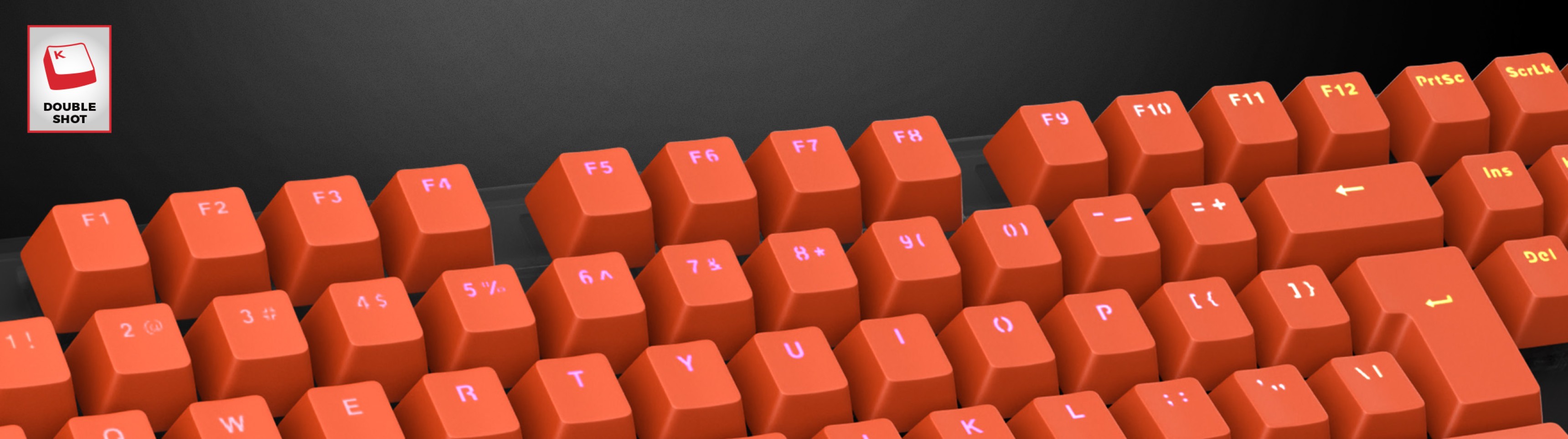 Teclas de doble disparo de color naranja brillante dispuestas en un teclado, con letras claras en cada tecla