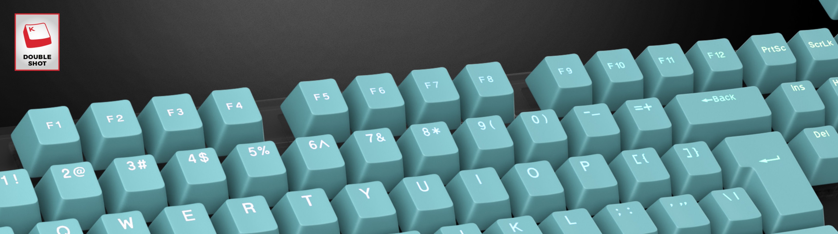 Teclados de doble disparo verde menta dispuestos sobre un teclado, con grabados de letras y números