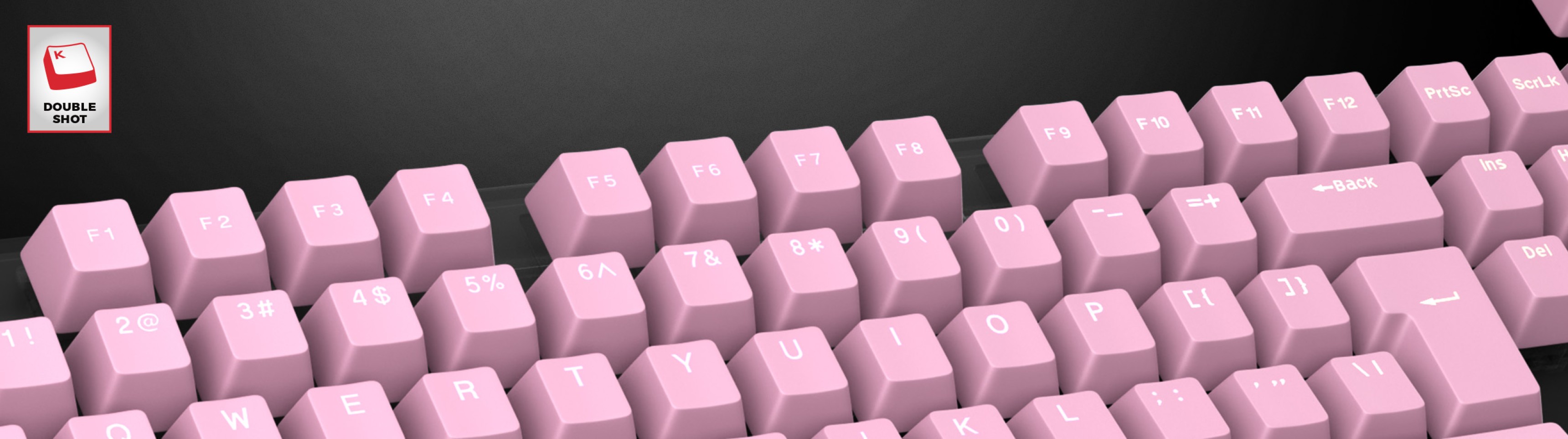 Teclas de doble disparo de color rosa pálido dispuestas en un teclado, con leyendas claras para cada tecla