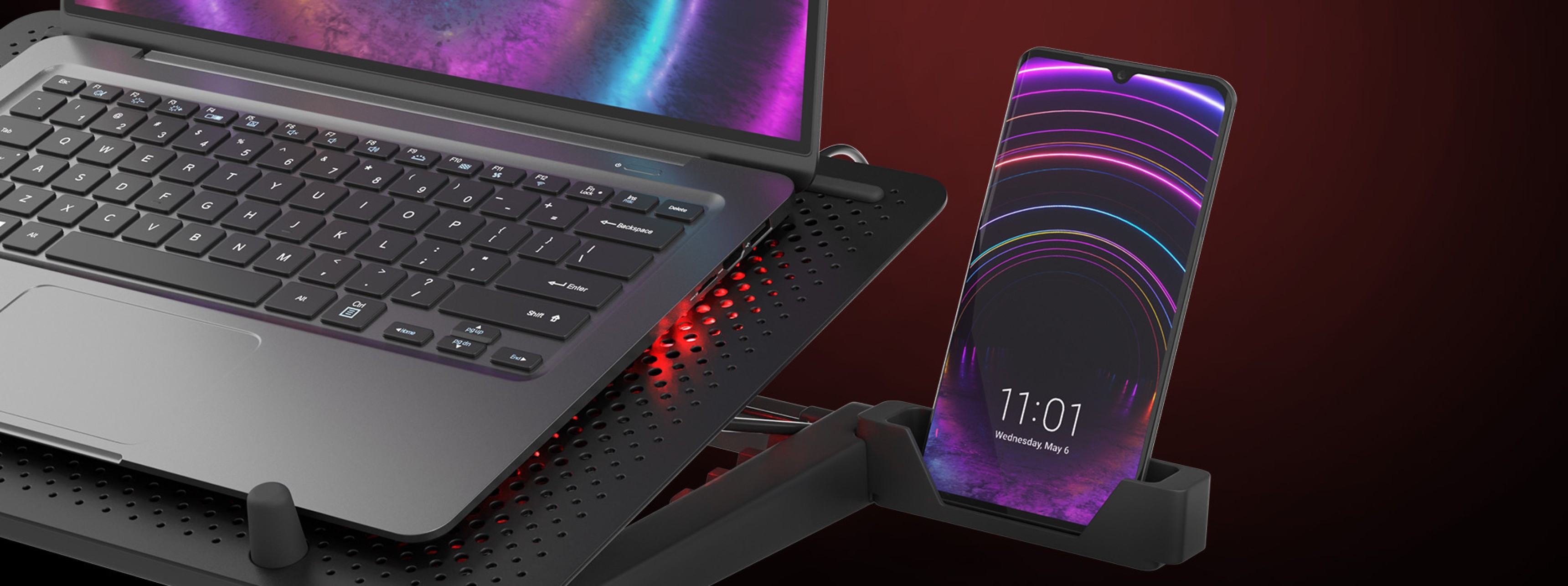 Almohadilla de refrigeración para portátil con cinco ventiladores, diseñada para portátiles de 15,6-17,3". Dispone de iluminación RGB y un puerto USB, con soporte para el teléfono