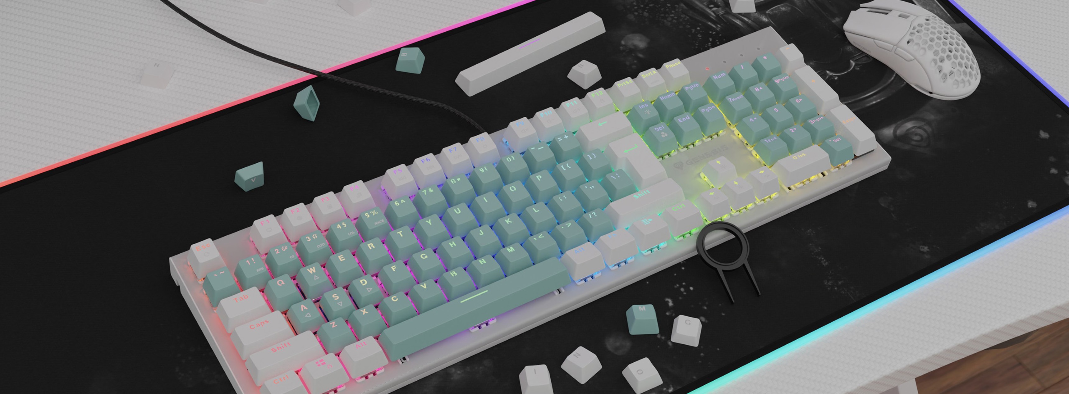 Teclas de doble disparo verde menta en un teclado retroiluminado, rodeado de pequeñas teclas blancas y un ratón gaming